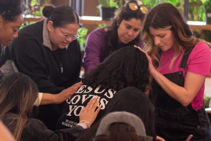 women praying at a bible study